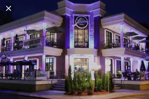 a building with purple lighting in front of it at 1-Bedroom Cozy Sweet #22 by Amazing Property Rentals in Gatineau
