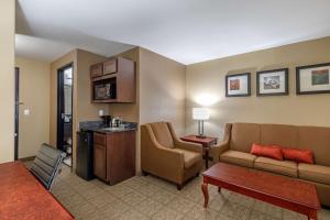 a living room with a couch and a table at Comfort Suites Ennis in Ennis