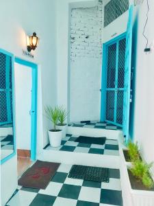 a room with a blue wall and a blue floor at Gypsy Child Lake Hostel Udaipur in Udaipur