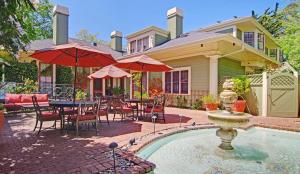 a house with a table and chairs and a fountain at Inn at Depot Hill in Capitola