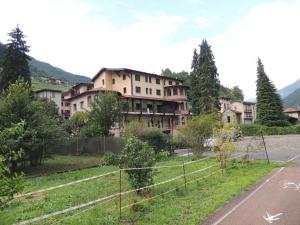 an old building on the side of a road at Ostello Brembo in Camerata Cornello