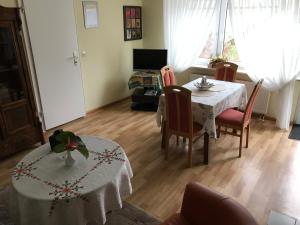 a living room with a table and chairs and a dining room at Apartment Baden Baden Haus am Ibachweg in Baden-Baden