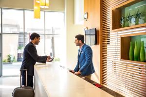 two men standing at a counter in an office at ibis Deira Creekside Dubai in Dubai