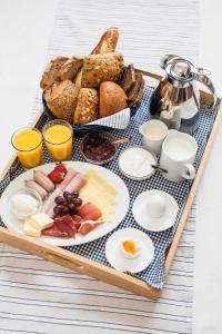 a tray of food with bread and eggs and toast at Gaestehaus Schaefersruh in Haffkrug