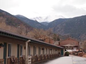 a row of buildings with snow capped mountains in the background at Eagle Motel in Manitou Springs
