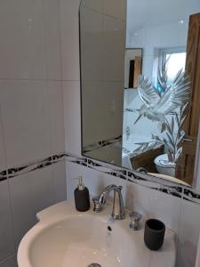 a bathroom with a sink and a mirror at Avon House in Telford