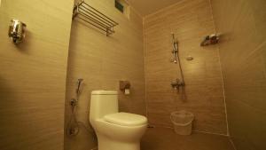 a bathroom with a toilet and a shower at Sunvalley Homestay in Coonoor