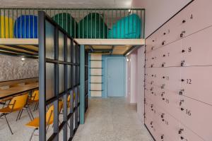 a hallway with lockers and a table and chairs at Back2ME in Batumi