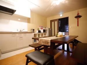 a kitchen with a table and a dining room at Nice Kyoto in Kyoto