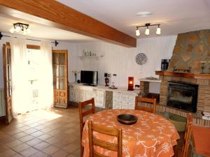 a living room with a table and a fireplace at Las mil y una noches in Tramacastilla