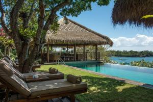 a resort with a swimming pool and a gazebo at Villa Sayang in Nusa Lembongan