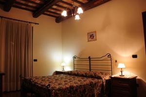 a bedroom with a bed and two night stands with lamps at Il Casale in Treia