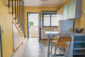a kitchen with a table and chairs in a room at Hanioti Home in Hanioti
