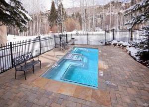 a swimming pool in a yard with a fence at Townsend Place Ski In Ski Out Access in Beaver Creek