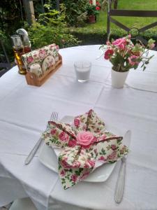 a white table with a plate with a bow on it at Family Hotel Bellehouse in Chernomorets