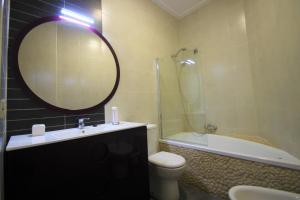 a bathroom with a sink toilet and a mirror at Apartamento CasaTuris cerca del aeropuerto de El Altet AT101 in Alicante