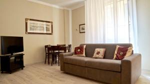 a living room with a couch and a television at Palazzo Colombini Apartment in Lucca