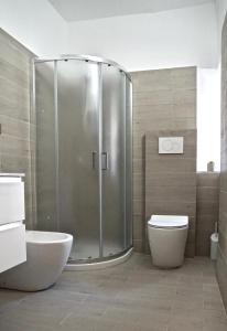 a bathroom with a shower and a toilet at Palazzo Colombini Apartment in Lucca