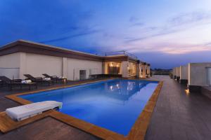 a large swimming pool on the roof of a house at Nataraj Sarovar Portico in Jhānsi