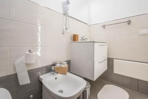 a white bathroom with a toilet and a sink at B&B Lo&G in Lascari +58 photos
