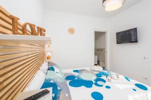 a bedroom with a bed with a computer on it at B&B Lo&G in Lascari