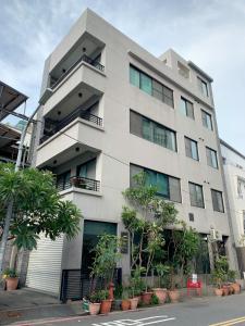 a white building with plants in front of it at 台南圈旅 in Tainan