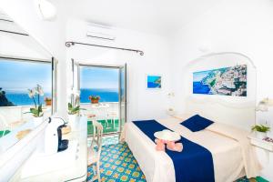 a bedroom with a bed and a view of the ocean at Casa Guadagno in Positano