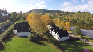 an aerial view of a house next to a river at Maison du Lac Vielsalm in Vielsalm