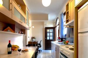 a kitchen with a counter with wine glasses on it at Giorgi's Blue Apartments in Kalathas