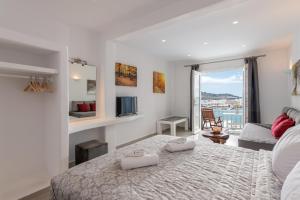 a bedroom with a bed with two towels on it at Magic View Suites Mykonos in Mikonos