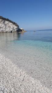a beach with rocks and the water at Hotel Acquamarina in Portoferraio