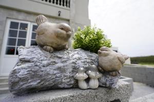 a statue of a bear and two birds on a rock at PENGHU Lucai B&B 旅采民宿 in Magong