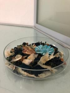 a bowl of food on a glass plate on a table at Hotel Acquamarina in Portoferraio