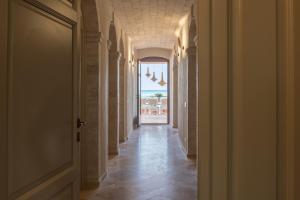 a hallway with a door and a view of the ocean at Villa Galatea in San Vincenzo