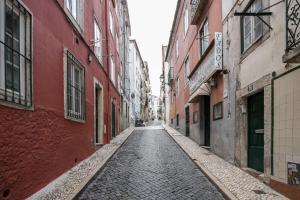 an empty street in an alley between buildings at Cozy Studio in Central Bairro Alto in Lisbon