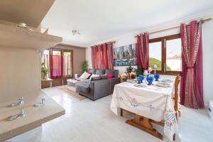 a living room with a table and a couch at Ropit in Port d'Alcudia