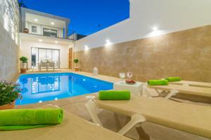 a living room with a pool and a house at Can Serra in Sa Pobla