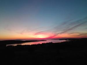 a sunset over a body of water at Villa Malena in Rab