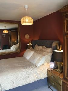a bedroom with a bed and a large mirror at Garden House in Masham