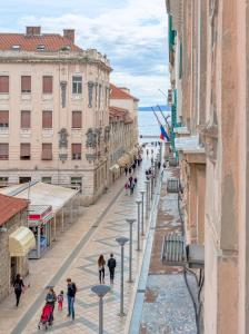 a street in a city with people walking on it at Luxury Rooms L'Avenue Split in Split