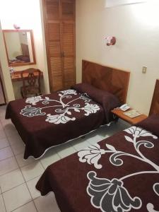 Postel nebo postele na pokoji v ubytování Hotel Citlalli Xalapa