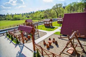 a playground with a slide and a swing set at ‘‘FOREST HOUSE ’‘ Будинок для відпочинку in Truskavets +24 photos