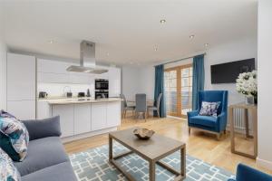 a living room with a couch and a table at Destiny Scotland - Royal Mile Residence in Edinburgh