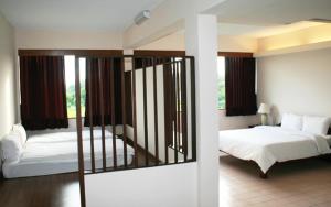 Postel nebo postele na pokoji v ubytování Mae Pim Resort Hotel