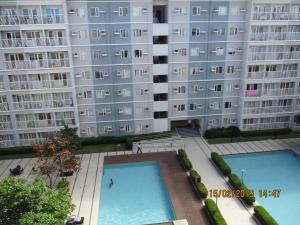 an apartment building with two swimming pools in front of it at XNY at SMDC Trees Residences Quezon City-1 Bed RoomT2 in Manila