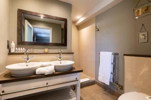 a bathroom with two sinks and a mirror at The Foley in Claygate