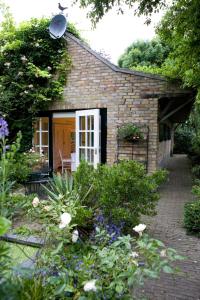 a brick house with a white door and some flowers at Veerhoeve in Sluis