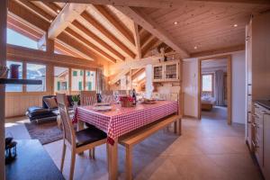 eine Küche und ein Esszimmer mit einem Tisch und Stühlen in der Unterkunft Chalet Aquila 7 Penthouse in Wengen