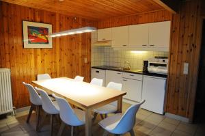 a kitchen with a table and chairs in a room at Libellule Style Vielsalm in Vielsalm