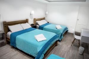 Postel nebo postele na pokoji v ubytování Hotel Ciudad Latin Palace